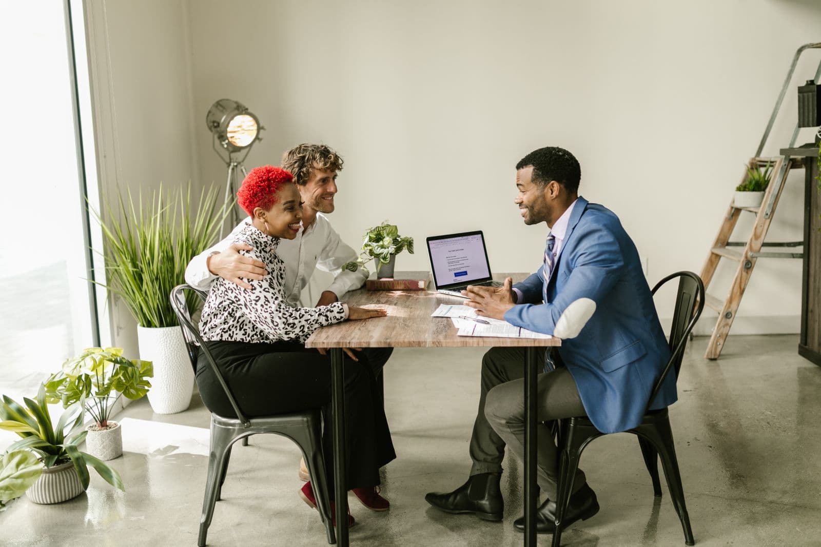 An adviser talks with a couple across a table